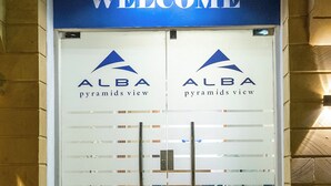 A welcome sign above a glass door with the logo 'ALBA pyramids view'. - Alba pyramids view inn (Giza)