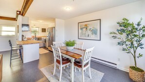 A modern kitchen with a wooden island, white chairs, and a potted plant. - 1 Mi to Skiing: Cozy Townhome in Beech Mountain! (Banner Elk)