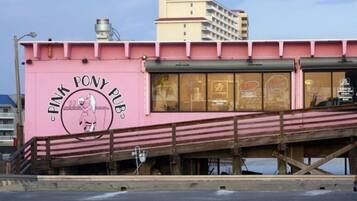 A pink building with a sign that reads "Pink Pony Pub."