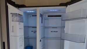 An open refrigerator with labeled compartments and a blue container inside. - Cosy room (Prévessin-Moëns)