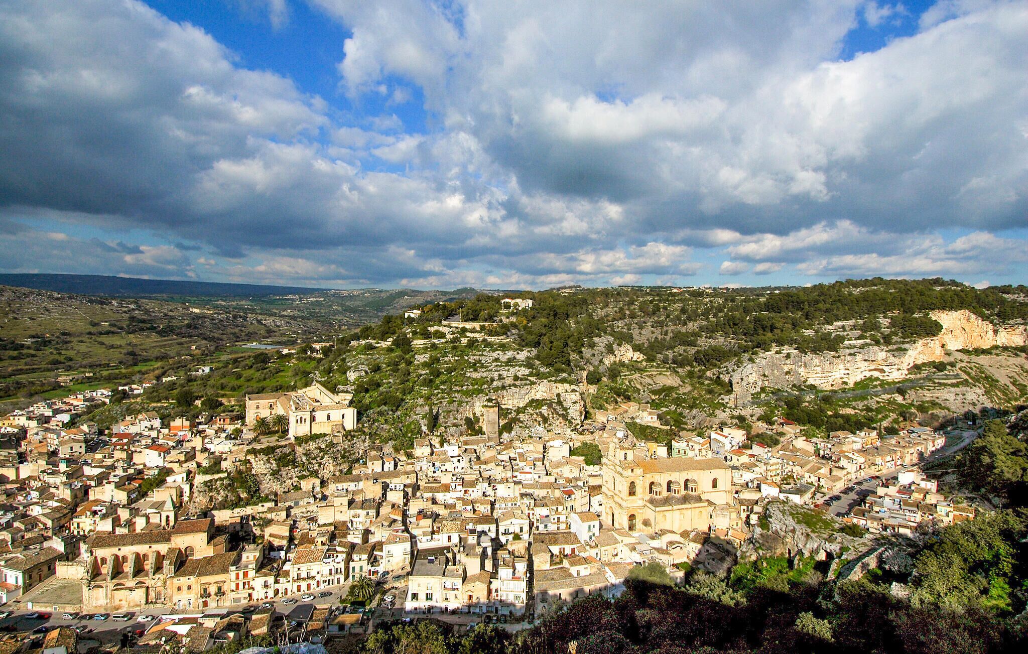 A densely packed town with historic buildings, narrow streets, and a prominent church.