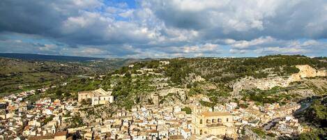 A densely packed town with historic buildings, narrow streets, and a prominent church.
