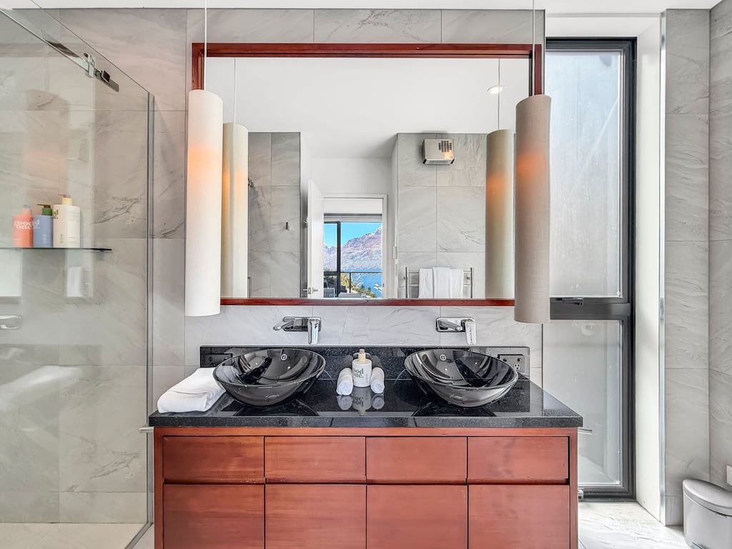 Stylish ensuite with double vanity, contemporary finishes and generous mirrors