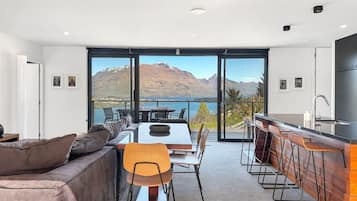 Spacious open-plan living and dining area with beautiful lake and mountain views