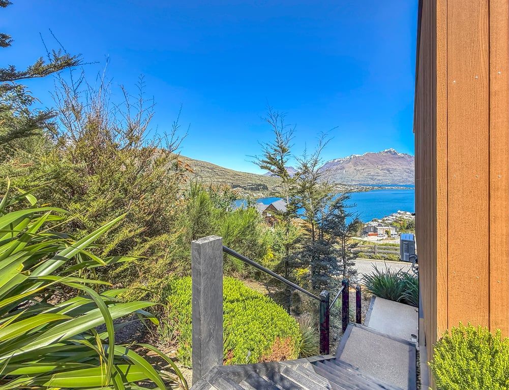 Surrounded by native landscaping with glimpses of Lake Wakatipu beyond
