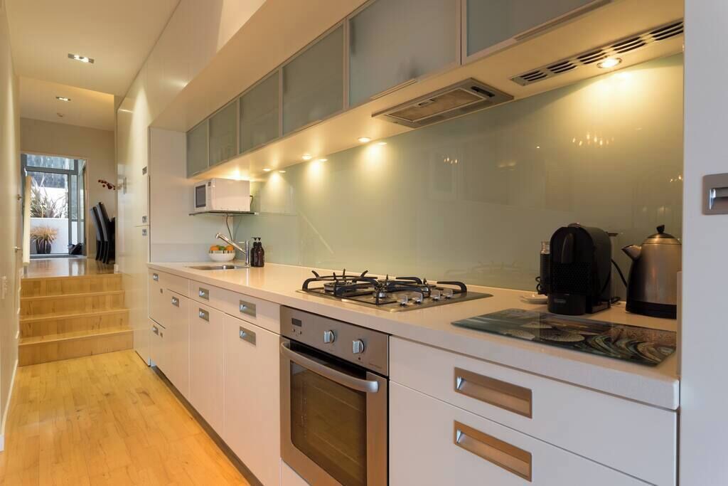 A modern kitchen with stainless steel appliances, a gas stove, and a microwave.