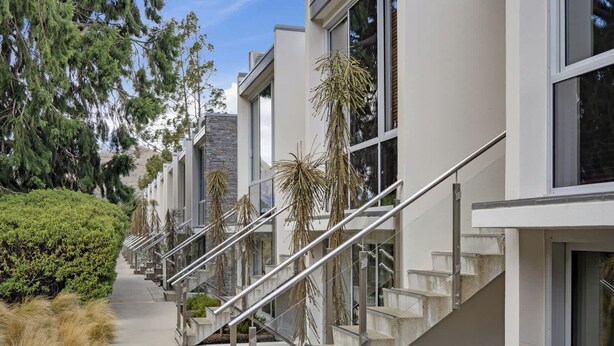 A modern building with a series of balconies and staircases.