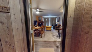 A wooden interior with a dining area, a sofa, and a ceiling fan. - Close to Lifts | Large Balcony | Mountain Spirits 103 (Angel Fire)
