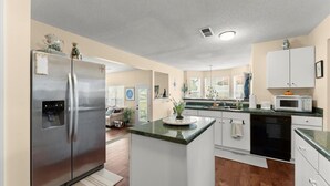 A modern kitchen with a stainless steel refrigerator, a microwave, and a dishwasher. - World Cup Work Base -Large Home + OFFICE- Sleeps 8 (Stonecrest)