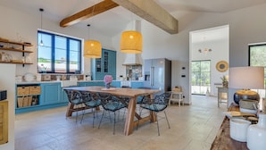 A modern kitchen with a large island, blue cabinets, and hanging wicker lights. - Villa Terossa (Kvarner - Skrbčići) (Skrbčići)