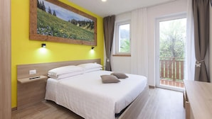 A bedroom with a bed, nightstands, a painting, a window, and a balcony.