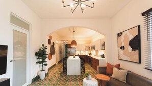 A modern interior with a dining area, kitchen, and living space.