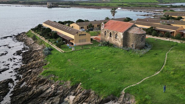 A coastal property with a stone building, a grassy lawn, and a pathway leading to the sea. - HOUSE ON THE SEA, WATERFRONT, BREATHTAKING VIEW WITH GARDEN AND PRIVATE BEACH (STINTINO)