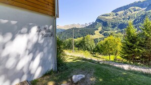 A building with a wooden roof and a sign reading 'Le Petit Ranch.' - Chalet "Le Petit Ranch" with Mountain View and Private Garden (Le Reposoir)