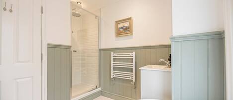 A bathroom with a shower, a sink, and a bathtub.