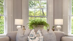 A beige sofa with multiple decorative pillows and two table lamps on either side. - Tucked away in a magical corner of Cornwall, South Lodge sits peacefully on the enchanting Bonython (Helston)