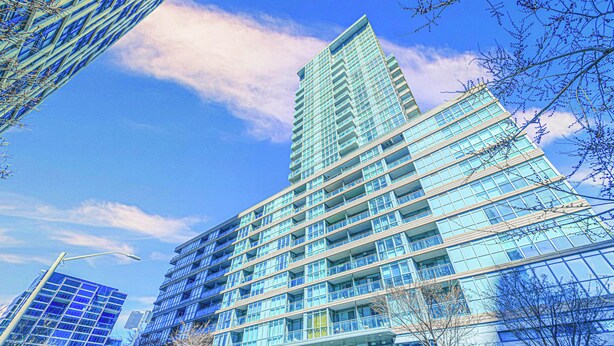 A modern high-rise building with multiple floors and large windows. - Panorama Suites-Fort York (Toronto)