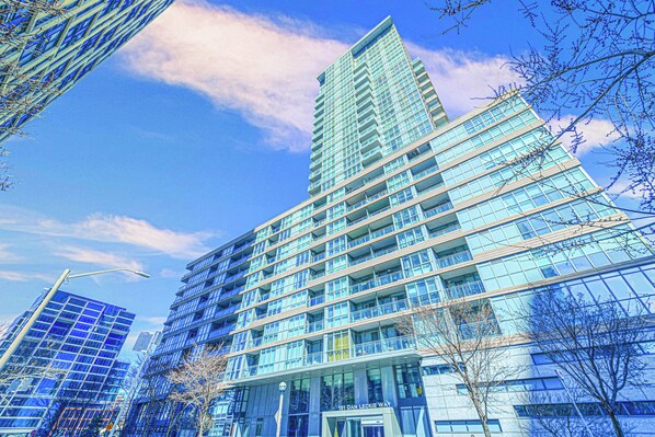 A modern high-rise building with multiple floors and large windows. - Panorama Suites-Fort York (Toronto)