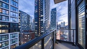 A high-rise building with multiple floors, large windows, and a view of the cityscape. - Panorama Suites-Fort York (Toronto)