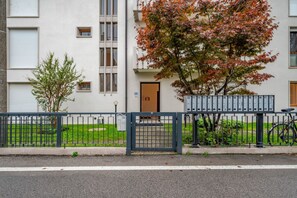 A building with a gated entrance, a mailbox, and a bicycle parked outside.