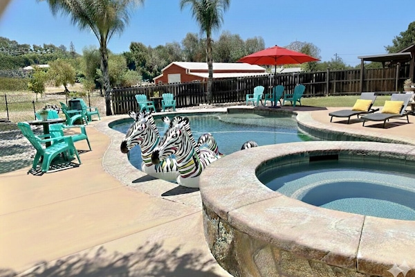 Heated pool overlooking peaceful ranch space designed for multi-family stays.