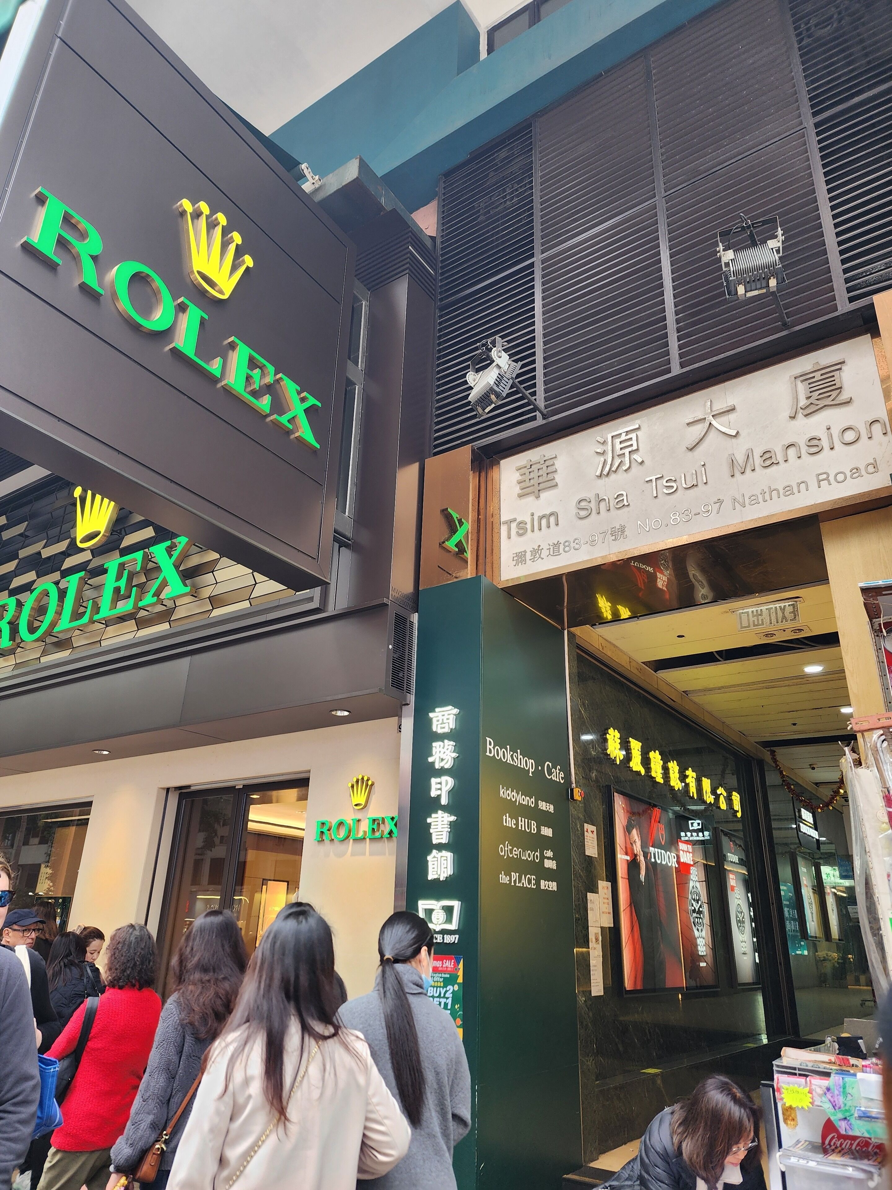 A storefront with a Rolex sign and a Tsui Mansion sign.