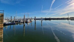 A marina with boats docked, calm water, and clear skies. - Apartment Nordseeperle - Comfortable apartment Nordseeperle with garden, (Dornum)