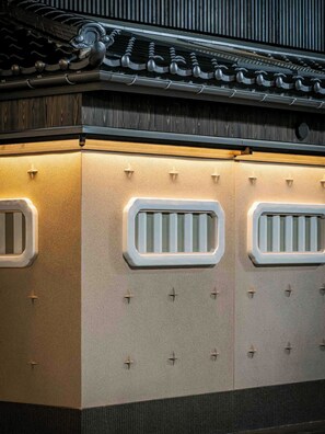 A traditional building with a tiled roof and decorative metal elements. - Ichika Machiya Holiday House (Takayama)