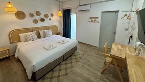 A modern bedroom with a large bed, bedside tables, a wooden desk, and a television. - Charm Hostel at Jomtien (Pattaya)