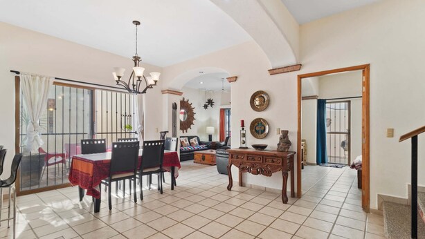 A spacious living area with a dining table, chairs, a sofa, and a coffee table. - Casa Sandy - Private Golden Zone Villa with Pool (Bucerías)