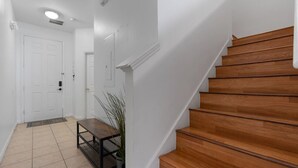 A staircase with wooden steps leading to a landing. - Cozy 3BDR House near Disney - AL (Kissimmee)