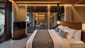 A modern hotel room with a large bed, a TV, and a view of the outdoor area. - The Kemilau Ubud (Ubud)