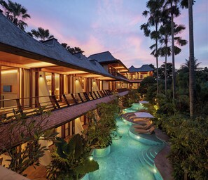 A resort with multiple guest rooms, a swimming pool, and lush tropical vegetation. - The Kemilau Ubud (Ubud)