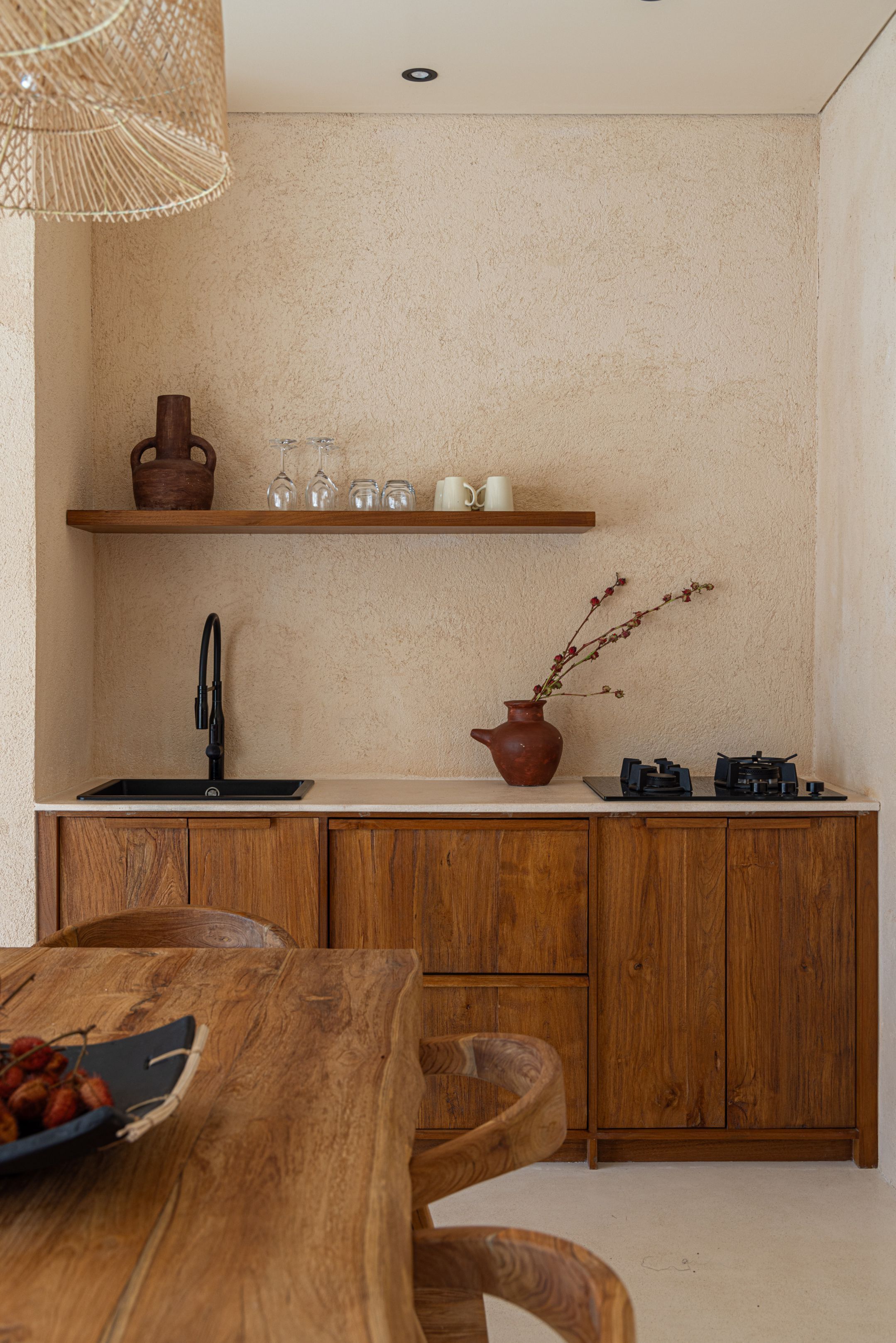 A kitchen with wooden cabinets, a sink, and a countertop.