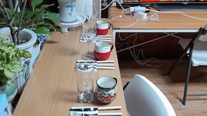 A dining table set with utensils, glasses, and a decorative bowl. - Disco PangPang GuestHouse (Foreigners only) (Incheon)
