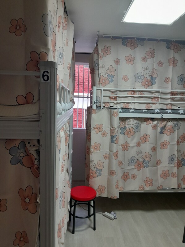 A child's room with bunk beds, a red stool, and floral curtains. - Disco PangPang GuestHouse (Foreigners only) (Incheon)