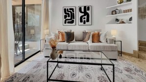 A modern living room with a sofa, coffee table, and decorative items.
