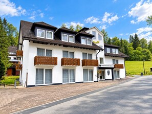 A two-story hotel with a white facade, multiple balconies with wooden railings, and a sign indicating 'SMART RESORTS B&B 2'. - Comfortable and versatile room -perfect for relaxation, work and exchange (Winterberg)