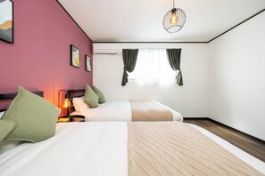 Relax in a serene space with a large bed, bedside table, and framed artwork.
