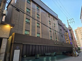 Um hotel de vários andares com uma placa chamativa para 'R Motel Riviera'.