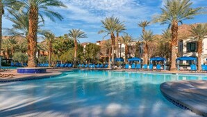 A pool area with blue lounge chairs and palm trees. - La Quinta Luxe C | Studio Legacy Villa (La Quinta)
