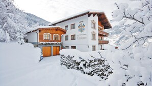 A snow-covered building with a traditional architectural style, featuring a wooden facade and multiple windows. - Apartment in Arzl With Wellness Area (Arzl im Piztal)