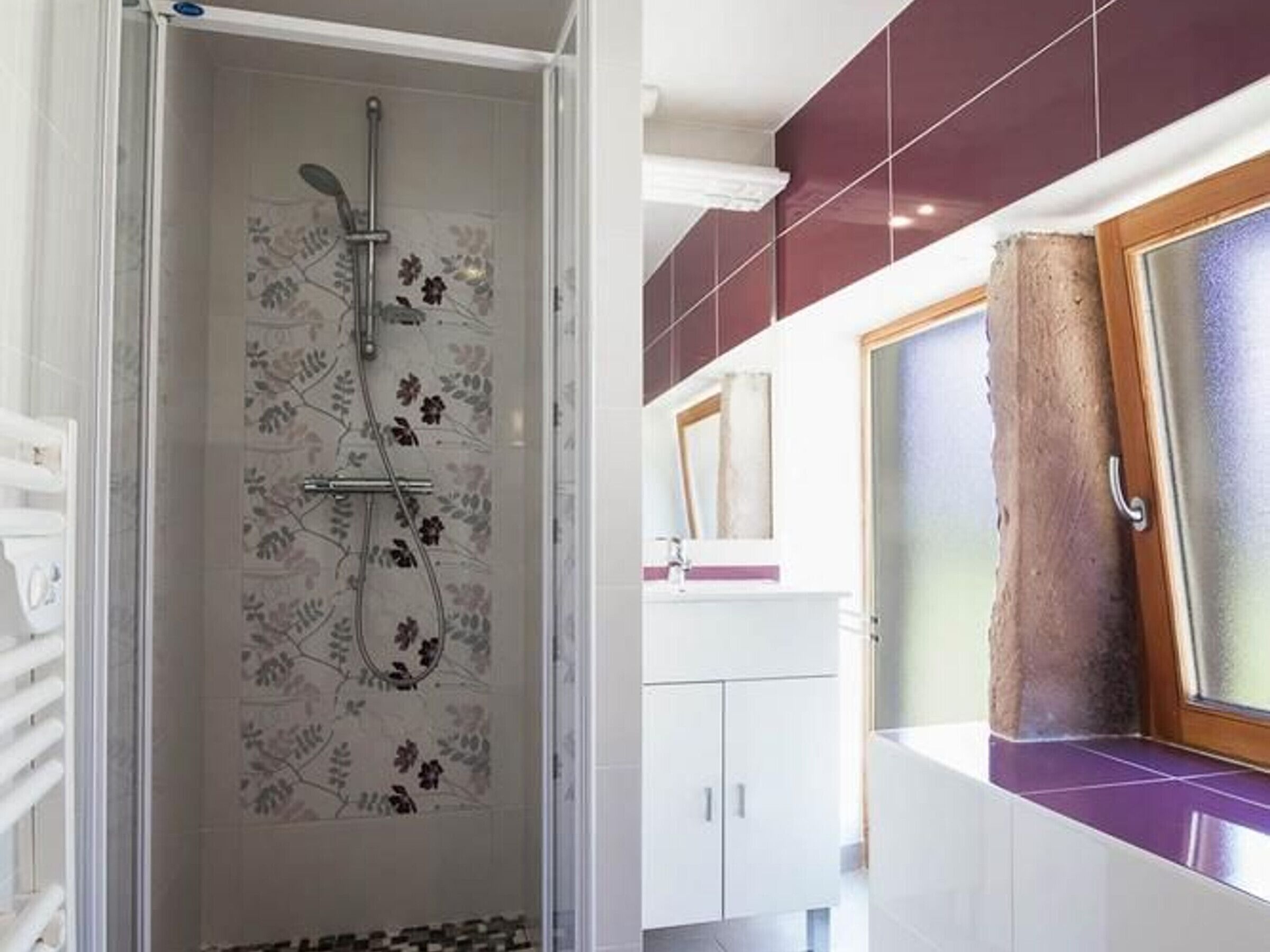 A bathroom with a shower, a sink, and a mirror.