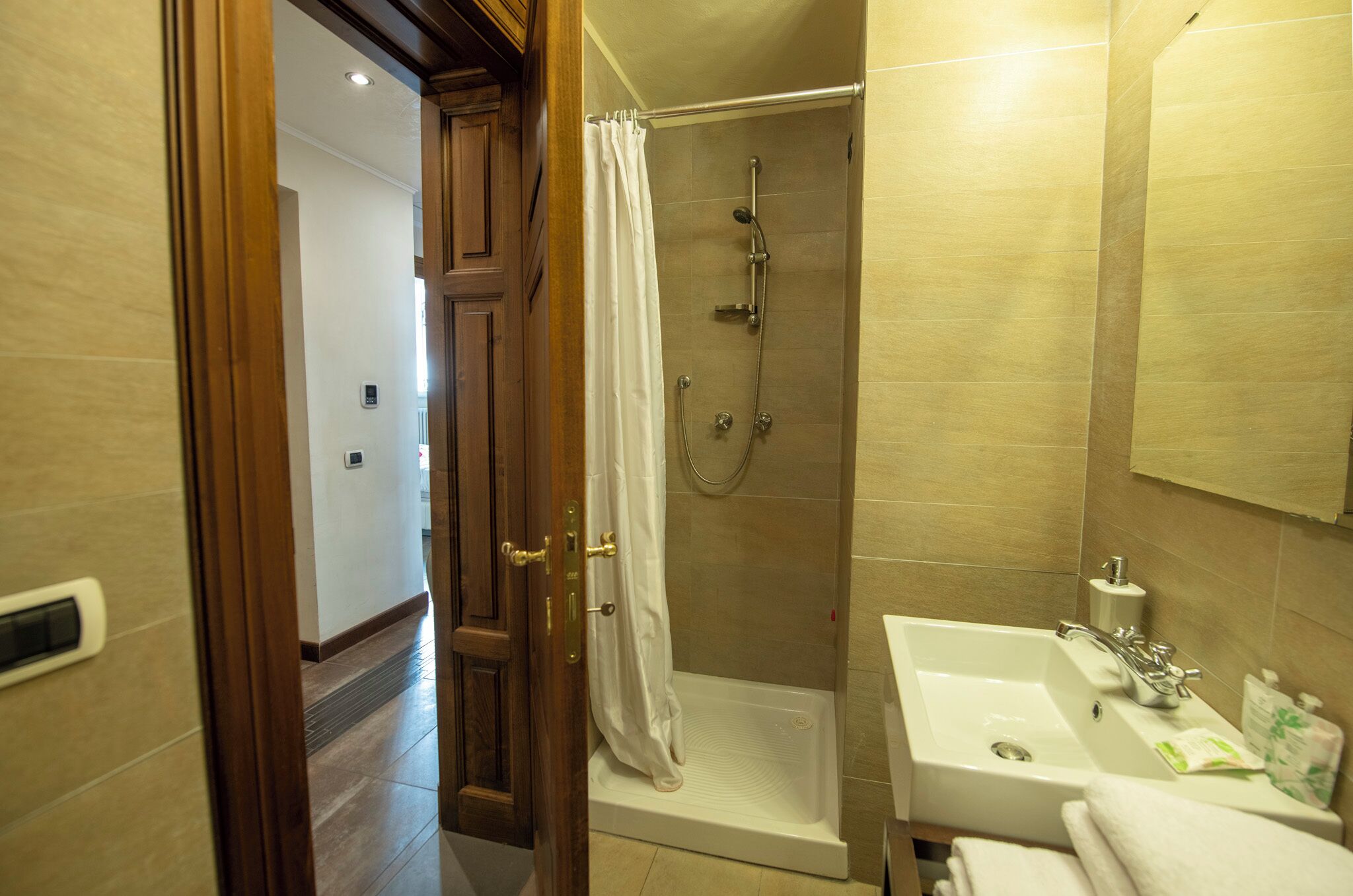 A bathroom with a shower, sink, and toilet.