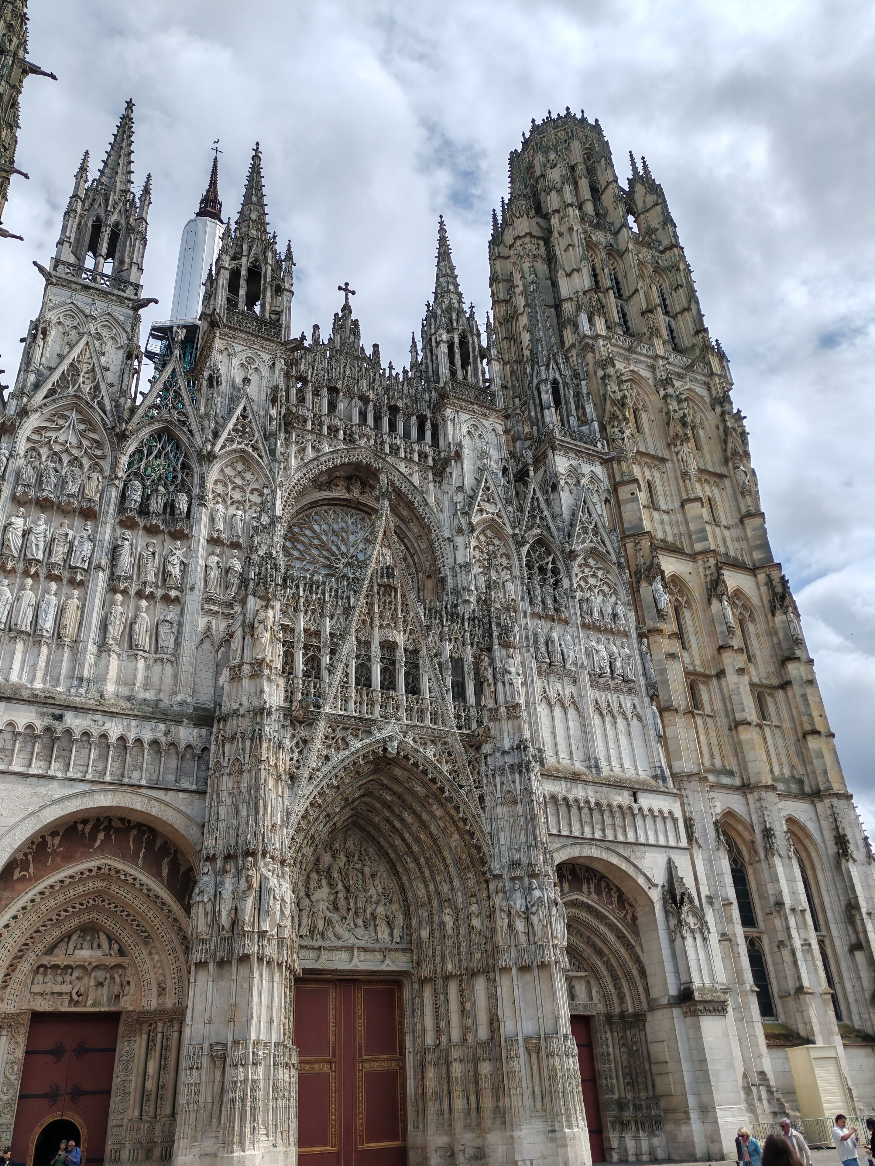 A Gothic cathedral with intricate stone carvings and multiple spires.
