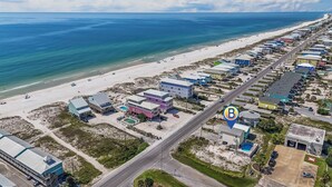 An aerial view of a coastal area with a beach, a road, and a row of buildings. - Gulf view retreat w/ Private pool at Summer Salt! (Gulf Shores)
