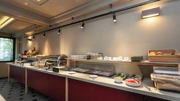 A buffet setup with various food items and a clear glass display case.