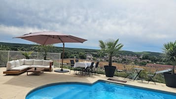 Seasonal outdoor pool, open 9:00 AM to 9:00 PM, pool umbrellas