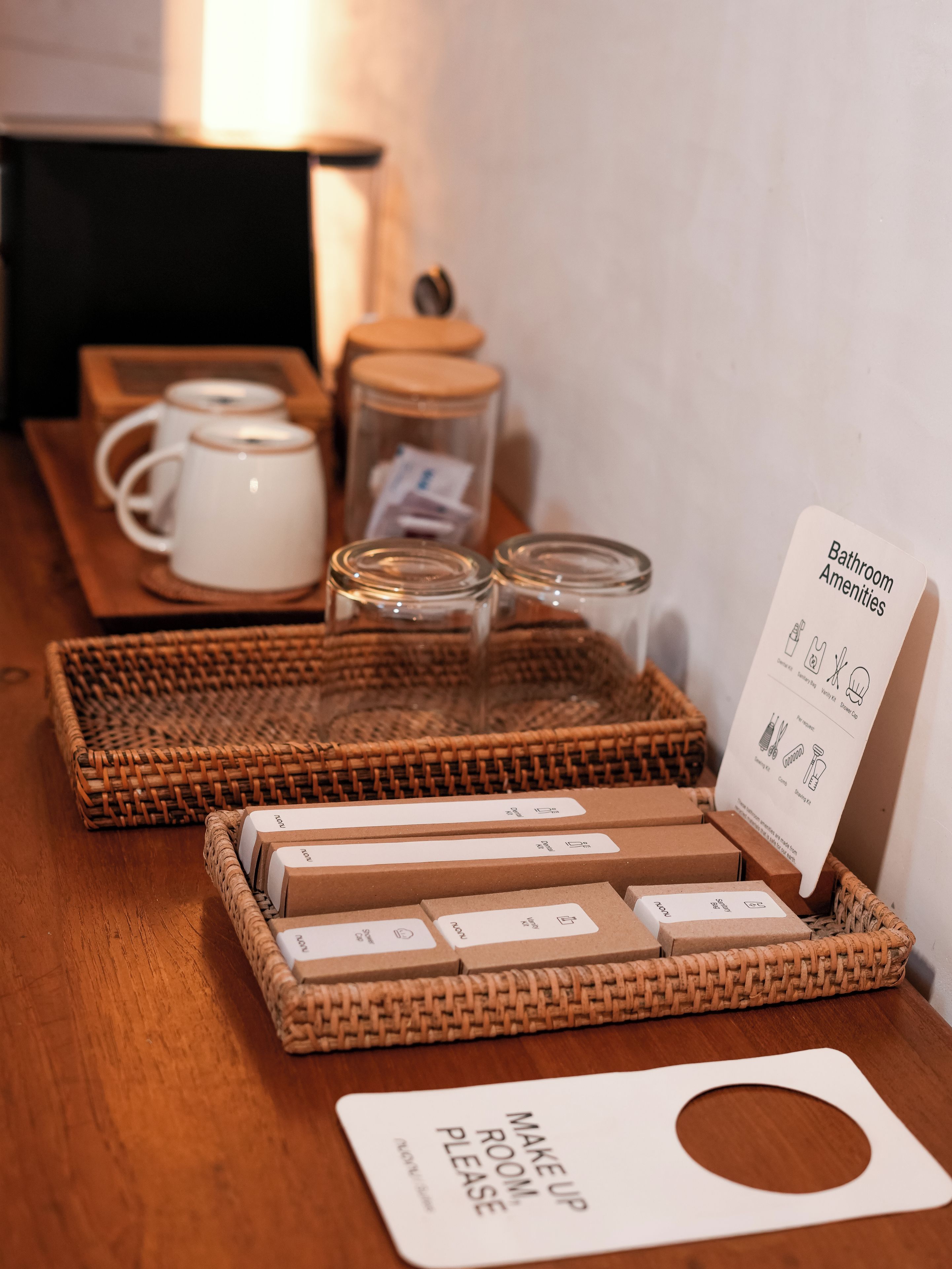 A set of amenities including a tea set, jars, and a sign for bathroom amenities.