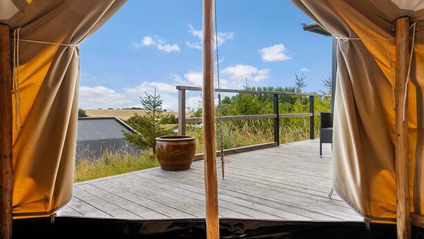 A tent with a wooden deck, a metal railing, and a view of the countryside. - Lovely home in Sejerø with WiFi (Sejerø)